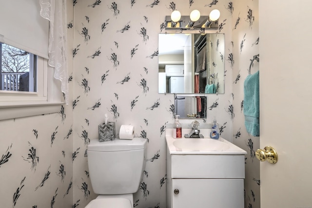 bathroom featuring toilet and vanity