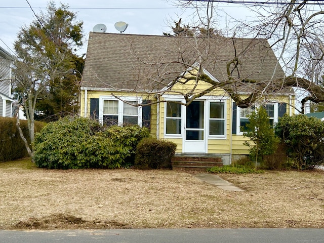 view of front of property featuring roof with shingles and entry steps