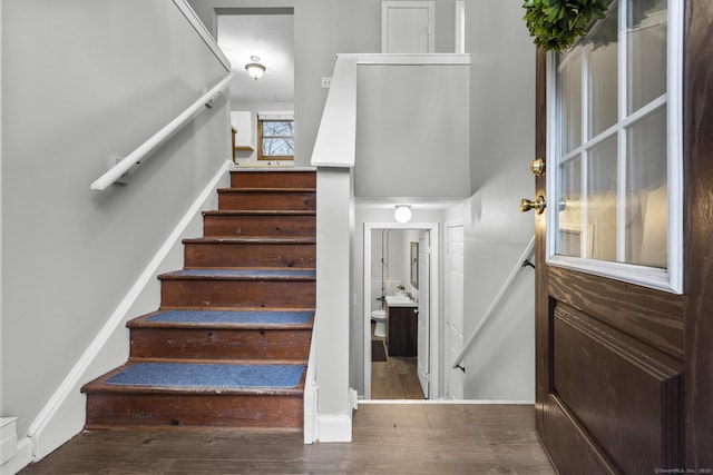 stairs featuring baseboards and wood finished floors