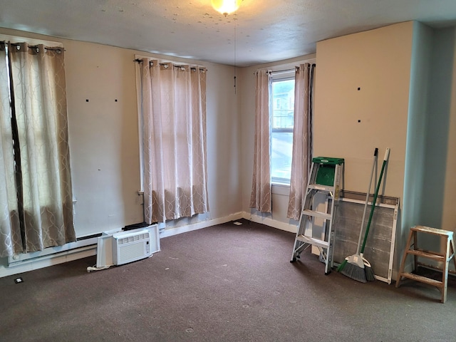 interior space with carpet floors, baseboards, and a wall mounted AC