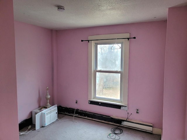 carpeted spare room with a textured ceiling and a wall mounted AC