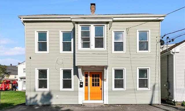 view of front facade featuring a chimney