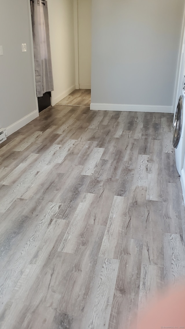 empty room featuring baseboards and wood finished floors