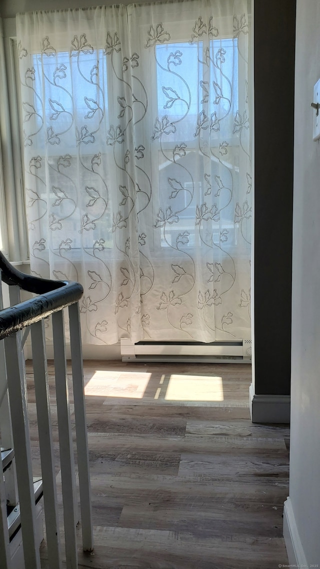 details with a baseboard radiator and wood finished floors