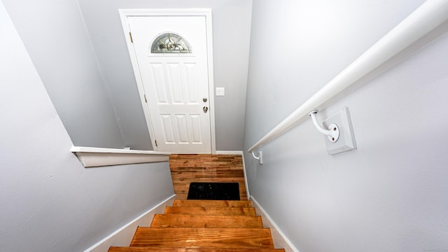 staircase featuring baseboards