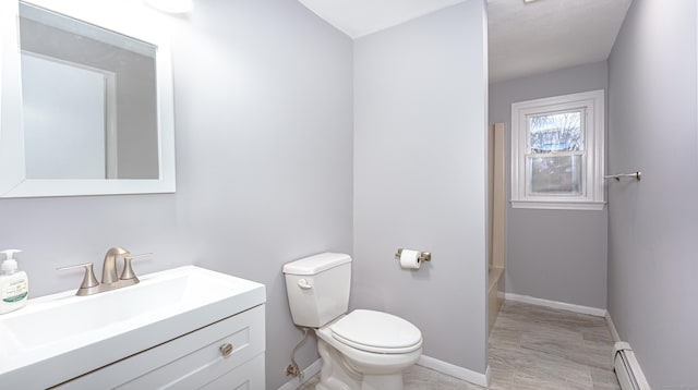 full bathroom with toilet, a baseboard radiator, baseboards, and vanity