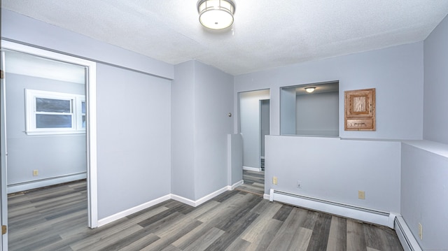 unfurnished room featuring a baseboard radiator and wood finished floors