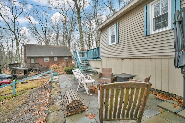 view of patio with stairs and a deck