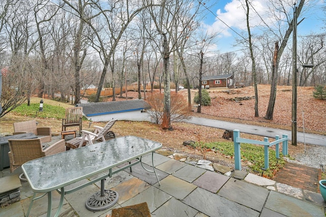 view of patio with an outbuilding