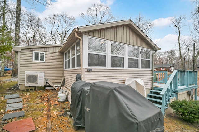 back of property featuring ac unit and a deck