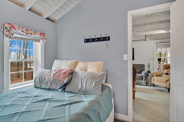 carpeted bedroom featuring lofted ceiling with beams and wooden ceiling