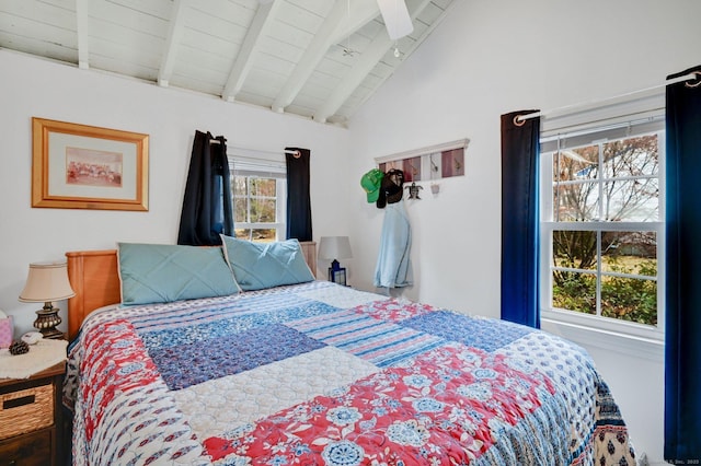 bedroom with lofted ceiling with beams and wooden ceiling