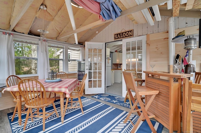 sunroom / solarium featuring lofted ceiling with beams