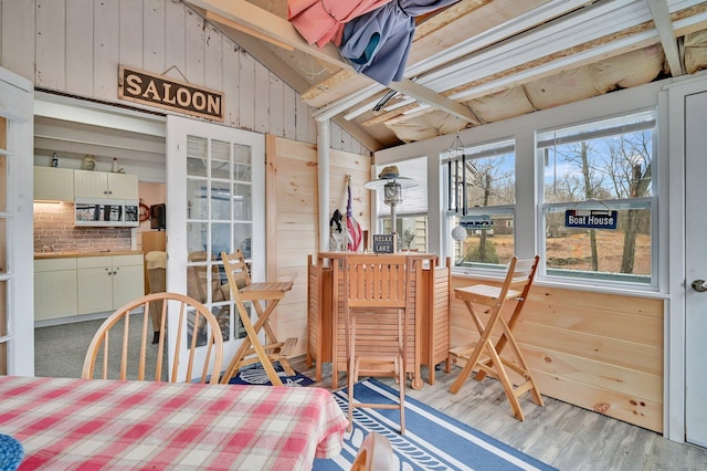 sunroom featuring vaulted ceiling