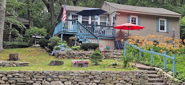 exterior space with stairs and a front yard