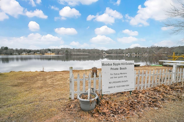 property view of water featuring fence