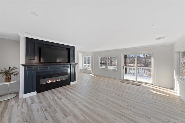 living room with a glass covered fireplace, crown molding, light wood-style flooring, and baseboards