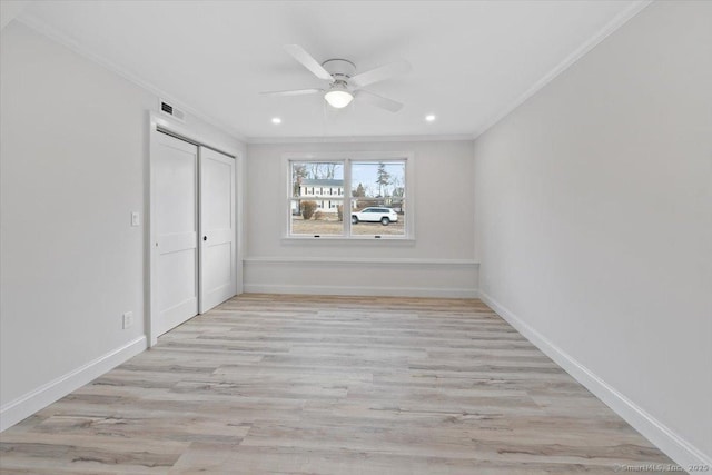 unfurnished bedroom with visible vents, baseboards, crown molding, and wood finished floors