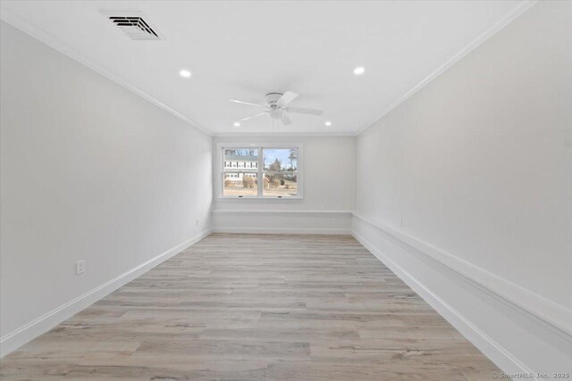 unfurnished room featuring crown molding, visible vents, light wood-style flooring, ceiling fan, and baseboards