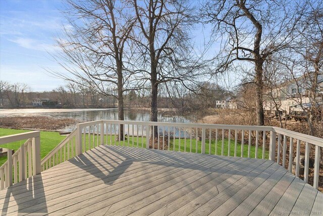 deck featuring a water view and a yard