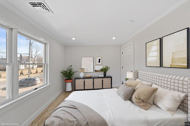 bedroom featuring recessed lighting, visible vents, baseboards, ornamental molding, and light wood finished floors