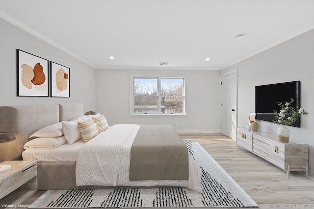 bedroom featuring recessed lighting, visible vents, ornamental molding, light wood-style floors, and baseboards