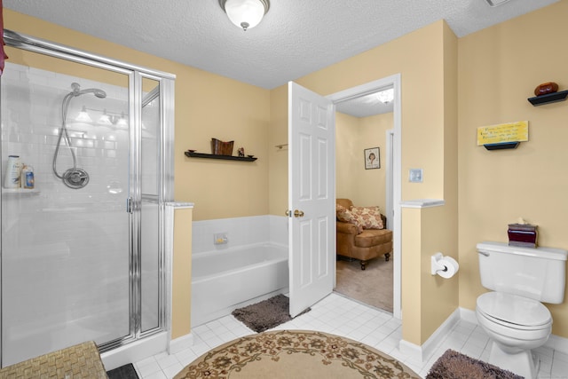 bathroom with a stall shower, a textured ceiling, toilet, and a bath