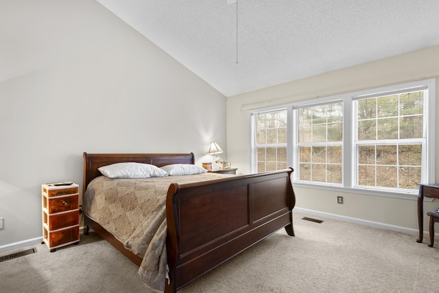 bedroom with vaulted ceiling, carpet flooring, visible vents, and baseboards