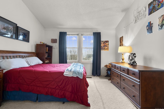 bedroom with light carpet and a textured ceiling