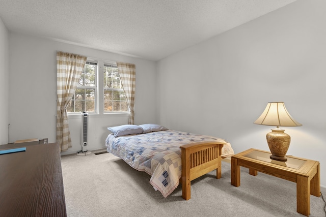 bedroom with a textured ceiling and carpet flooring