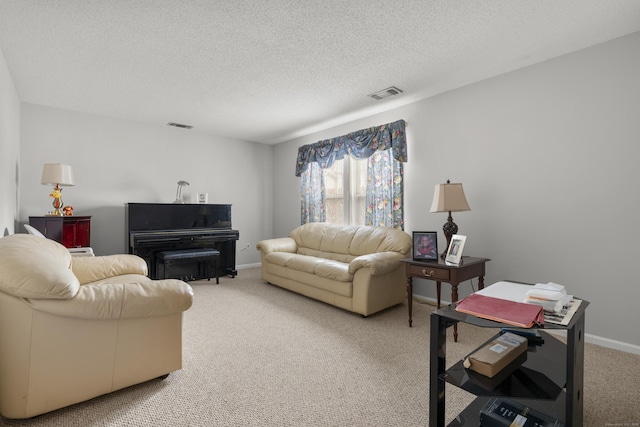 living room with light colored carpet, visible vents, a textured ceiling, and baseboards