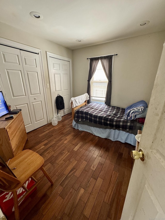 bedroom with dark wood-type flooring and recessed lighting