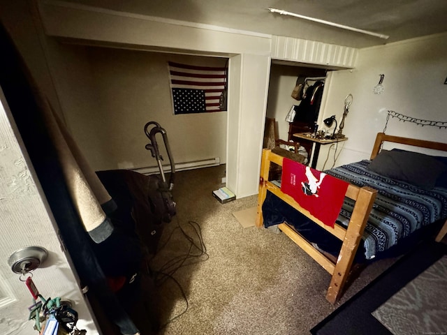 bedroom with a baseboard heating unit and carpet floors