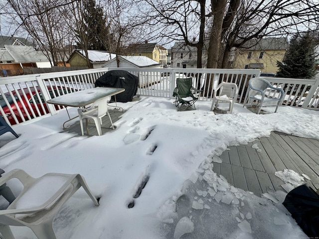 snow covered deck featuring a grill