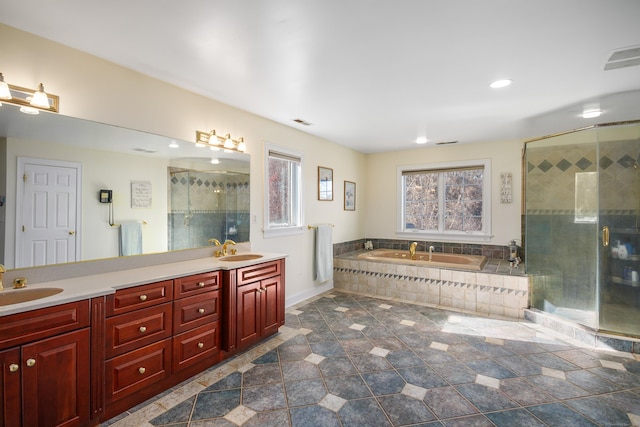 bathroom with a garden tub, double vanity, a sink, and a shower stall