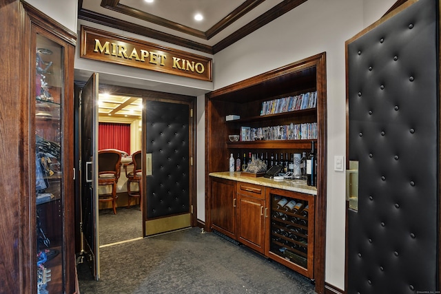 bar with beverage cooler, baseboards, dark colored carpet, a dry bar, and crown molding