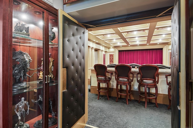 home theater featuring crown molding, a dry bar, carpet flooring, coffered ceiling, and beamed ceiling