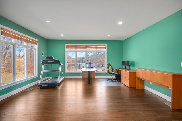 office space with dark wood-style floors, recessed lighting, plenty of natural light, and baseboards