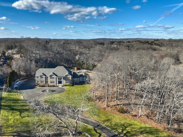 birds eye view of property featuring a wooded view