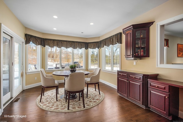 dining area with dark wood-style flooring, recessed lighting, visible vents, and baseboards