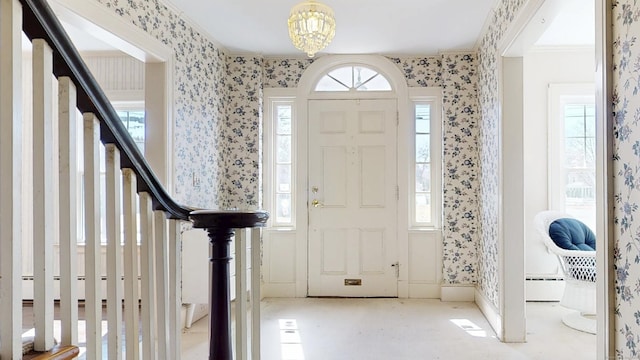 entrance foyer with a wealth of natural light, a baseboard radiator, and wallpapered walls