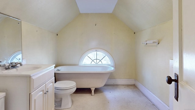 full bathroom with baseboards, toilet, a freestanding bath, lofted ceiling, and vanity