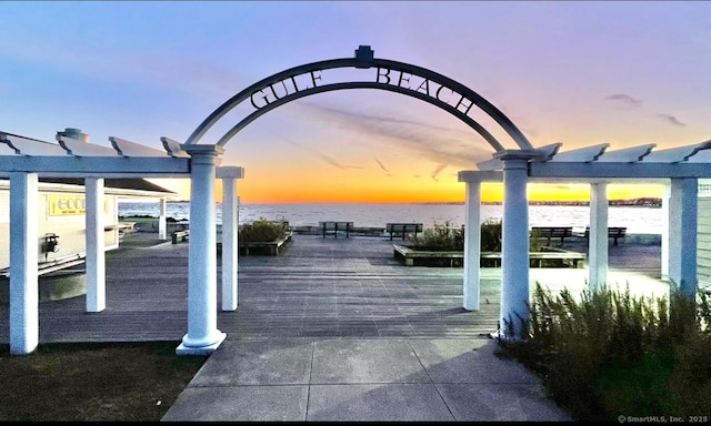 view of property's community with a pergola and a water view