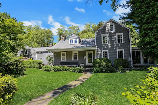 64 Old Kings Hwy S, Darien, CT 06820 - view of front facade with a chimney, a porch, and a front lawn