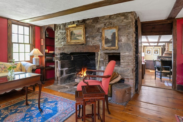 64 Old Kings Hwy S, Darien, CT 06820 - living area with a fireplace, wood-type flooring, and a textured ceiling