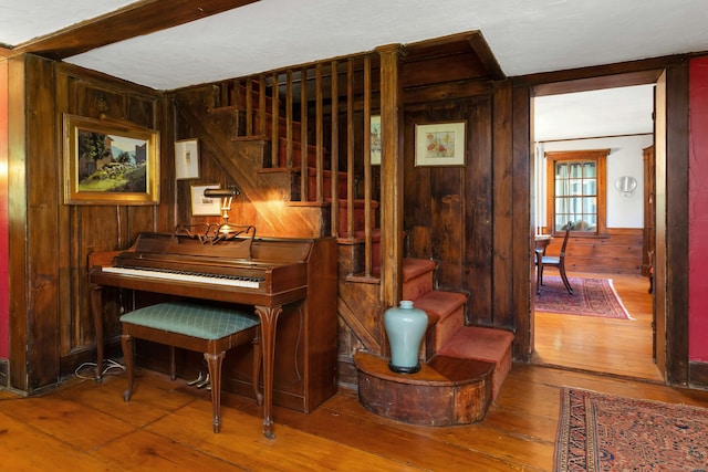 64 Old Kings Hwy S, Darien, CT 06820 - living area featuring wooden walls, wood-type flooring, and stairs