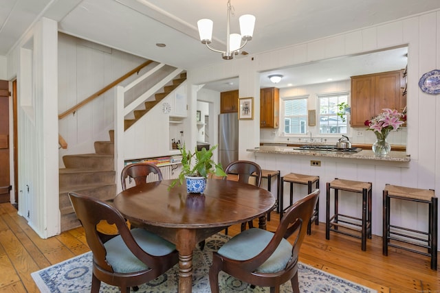 64 Old Kings Hwy S, Darien, CT 06820 - dining space with light wood-style flooring, stairway, and a chandelier