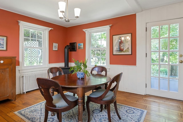64 Old Kings Hwy S, Darien, CT 06820 - dining space featuring radiator, light wood-style floors, a chandelier, a wainscoted wall, and a decorative wall