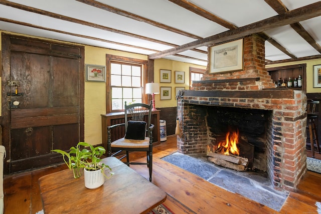 64 Old Kings Hwy S, Darien, CT 06820 - living area with beamed ceiling, hardwood / wood-style flooring, and a brick fireplace