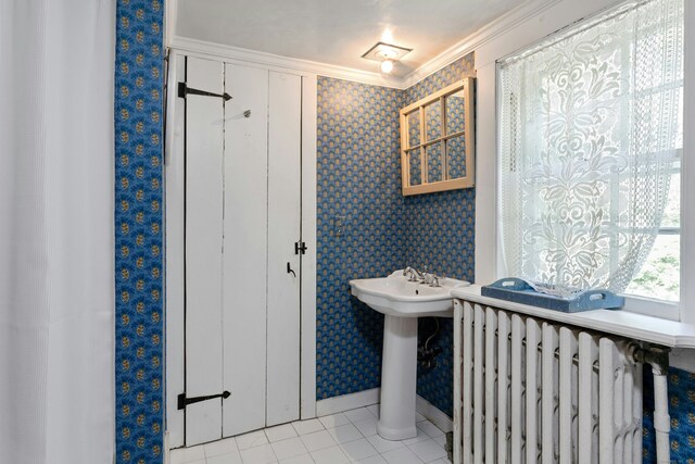 64 Old Kings Hwy S, Darien, CT 06820 - bathroom with radiator, wallpapered walls, ornamental molding, tile patterned floors, and a sink
